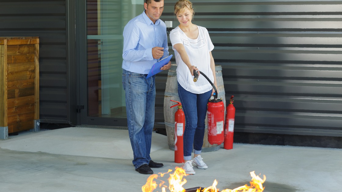 couple using a fire extinguisher
