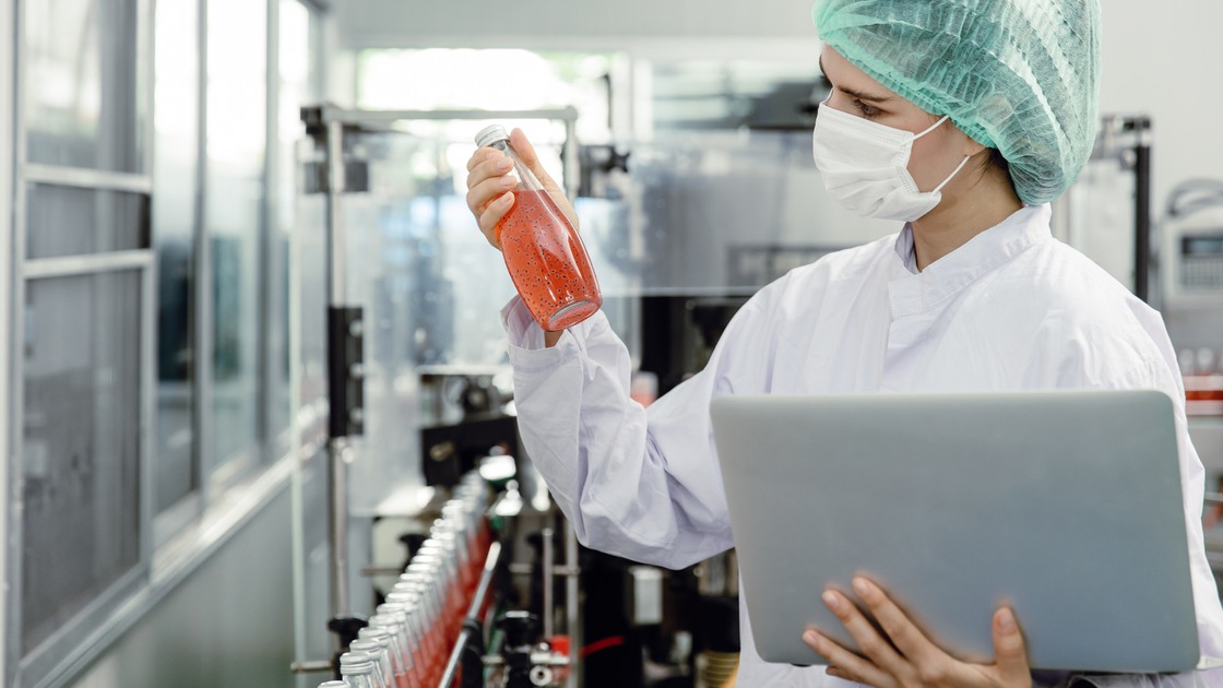 Quality control and food safety inspector test and check product contaminate standard in the food and drink factory production line with hygiene care.