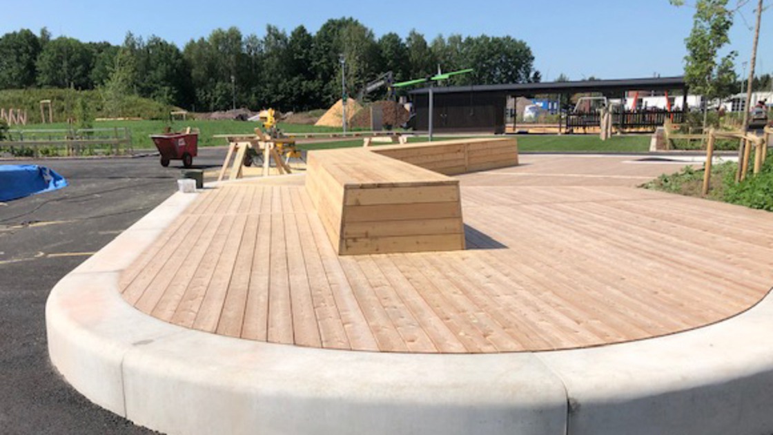 Trädäck med sittbänk på Baggeboskolans skolgård.