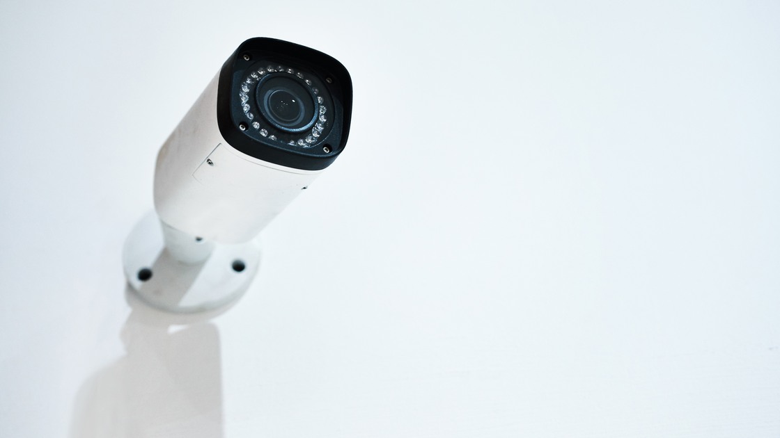 Camera, surveillance and office security on wall, protection and crime monitoring for criminal activity. Broadcasting, video and live feed for control room, movement detection and vigilance or safety.