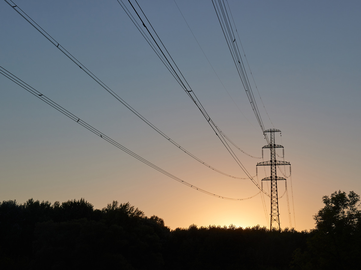 Power grid ultra high voltage electric line in sunrise light