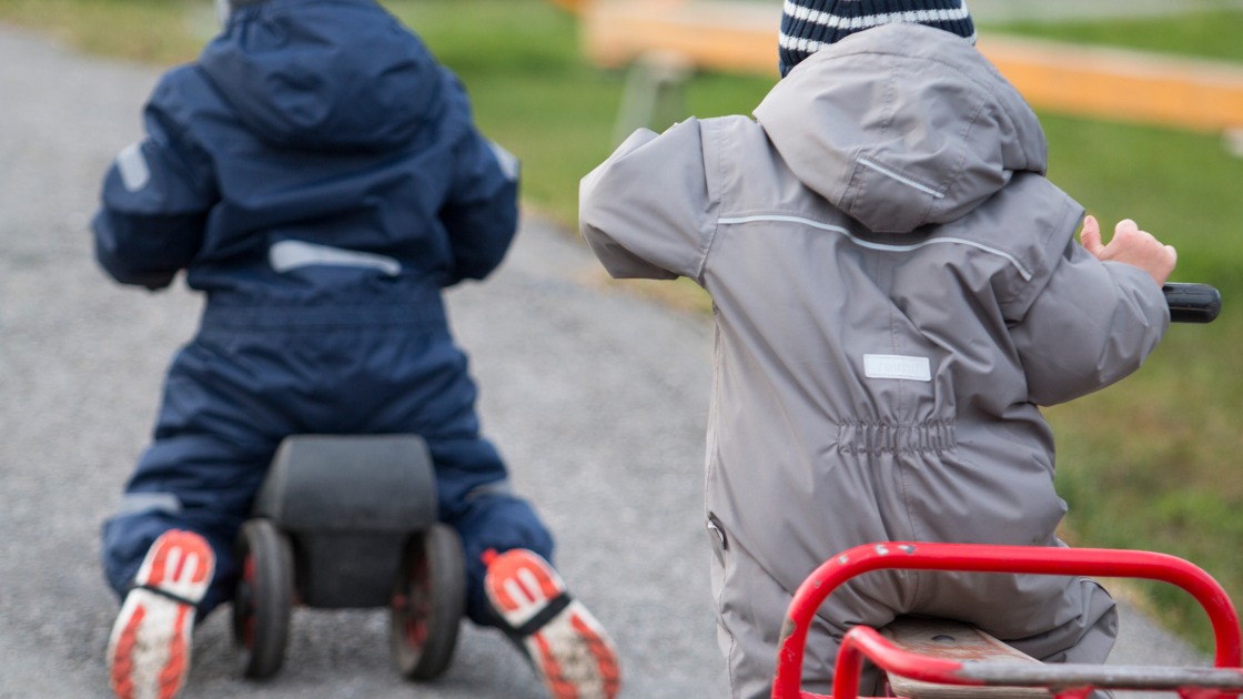 Barn åker på trehjulingar.